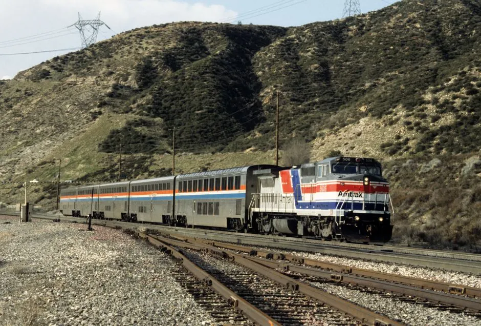 Amtrak train traveling through hills in California