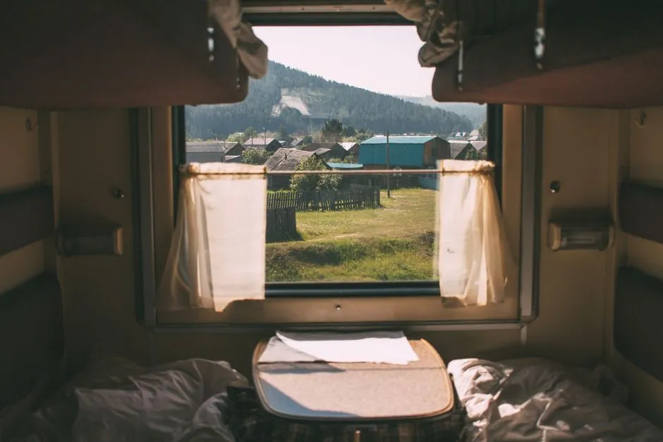 Sleeper train compartment interior with a window view